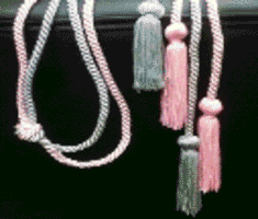 Kappa Mu Epsilon pink cord tied to a gray cord 