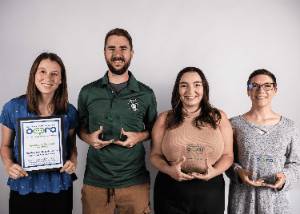 NSU University Relations team members display 2023 OCPRA awards. Pictured left to right are: Abby Kelley, Ryan Churchill, Rachel Mamone and Meg Watkins.