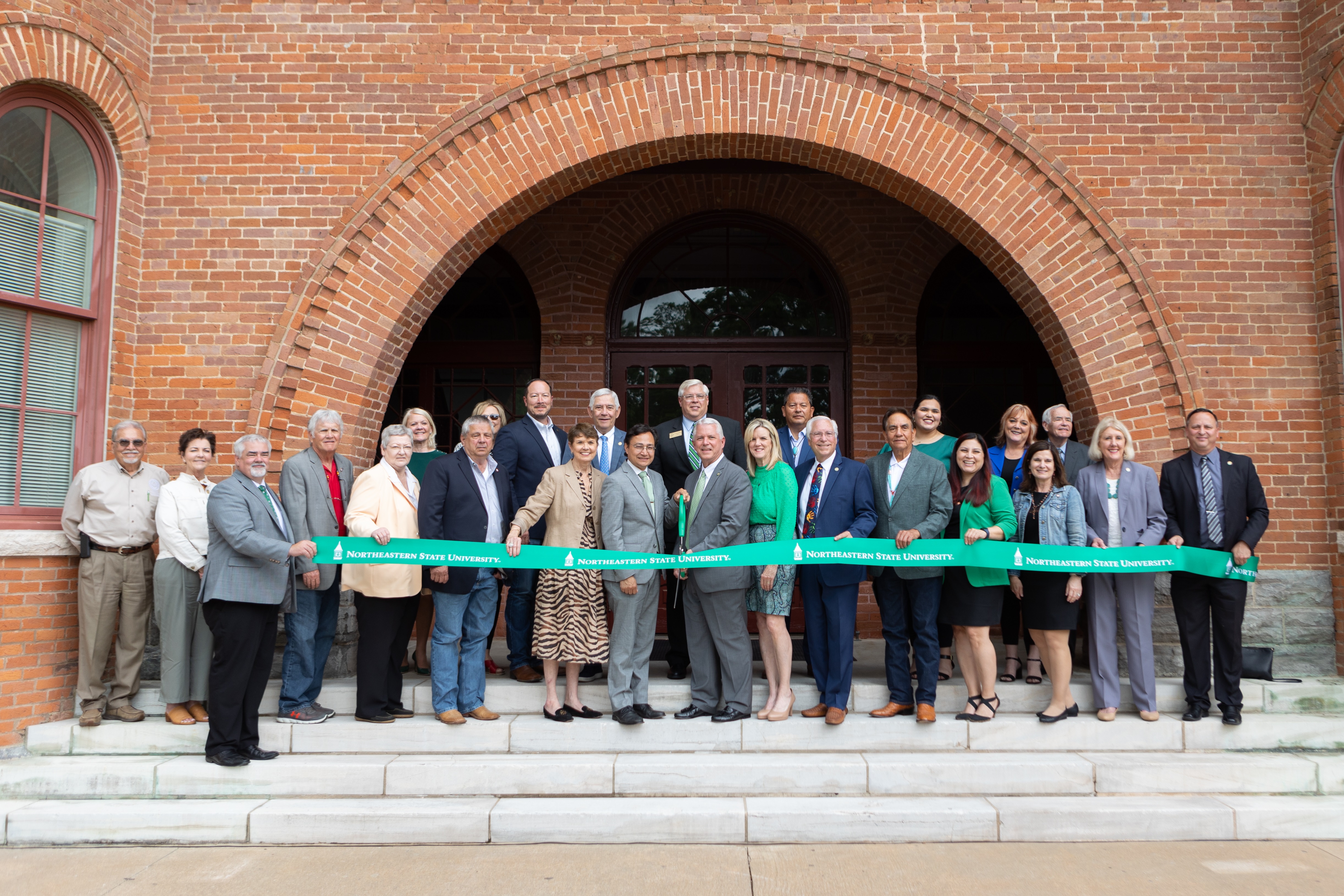 NSU, Cherokee Nation and other officials gather to cut the ribbon on the newly restored Seminary Hall and museum. 