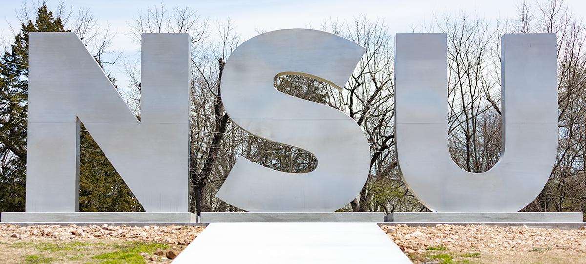 A stainless steel sign spelling out NSU